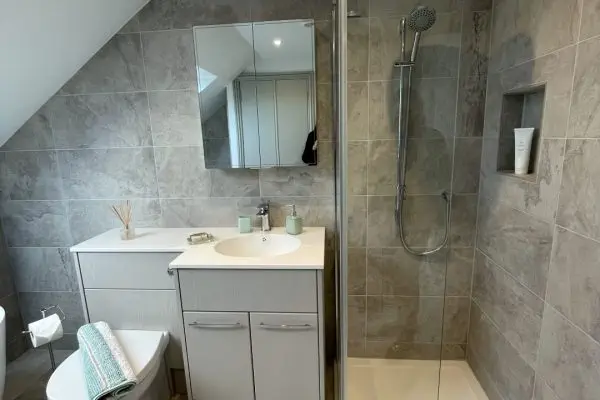 Large loft bathroom with freestanding bath, fitted furniture and walk-in shower_0750 (Large)