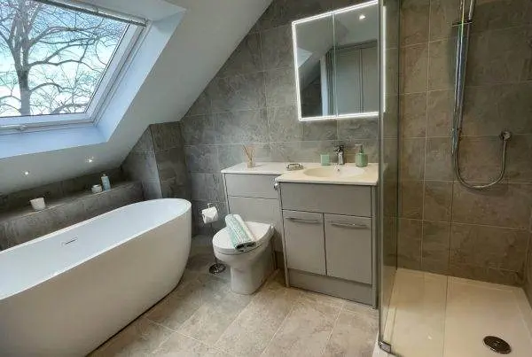 Large loft bathroom with freestanding bath, fitted furniture and walk-in shower_0754 (Large)