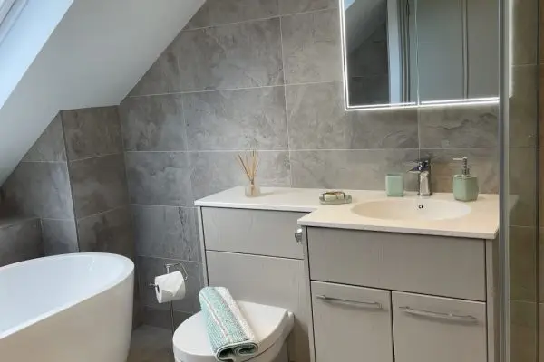 Large loft bathroom with freestanding bath, fitted furniture and walk-in shower_0755 (Large)